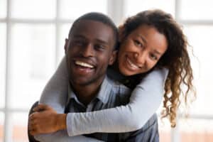 Attractive couple smiling with bright, beautiful teeth from dental bonding